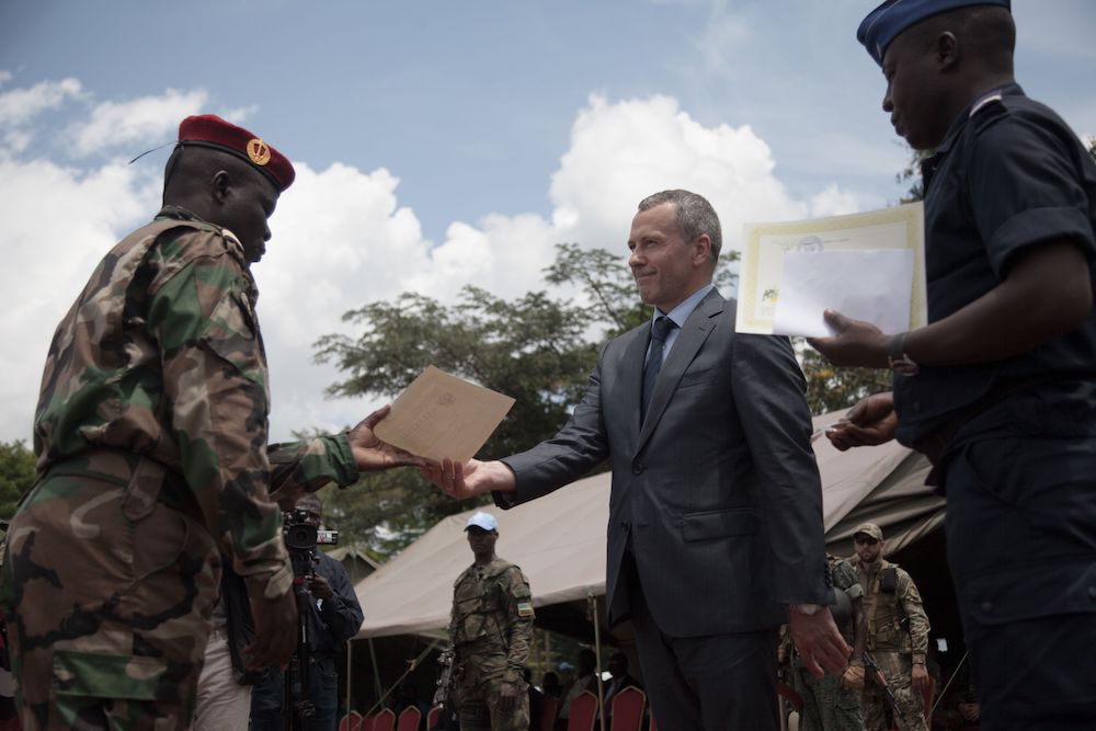 Victor Tokmakov presenting a graduation diploma to a recruit.